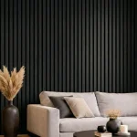 Black acoustic slat wood panels installed as a feature wall in a modern living room behind a grey sofa.