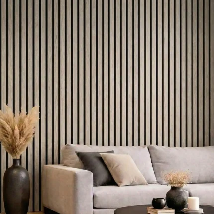 Light grey acoustic slat wood panels installed as a feature wall behind a grey sofa in a modern lounge.