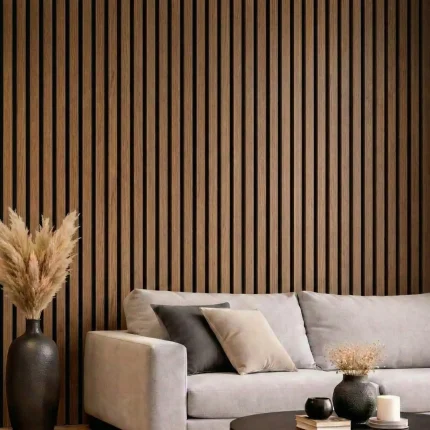 Walnut acoustic slat wood panels installed as a modern living room feature wall behind a grey sofa.