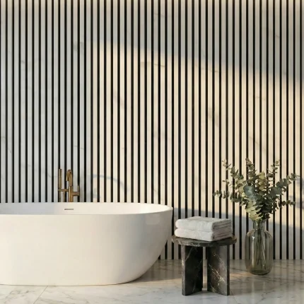 White marble acoustic slat wall panels installed as a feature wall in a luxury bathroom behind a freestanding tub.