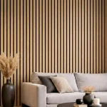 Natural oak acoustic slat wood panels installed as a feature wall behind a grey sofa in a modern lounge.
