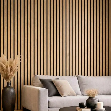 Natural oak acoustic slat wood panels installed as a feature wall behind a grey sofa in a modern lounge.
