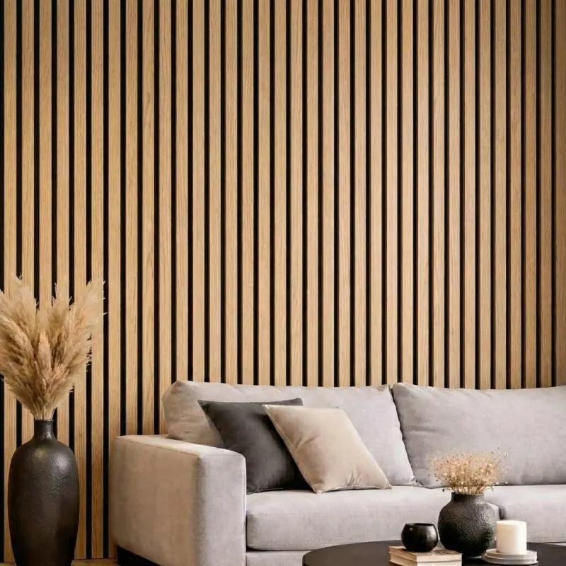 Natural oak acoustic slat wood panels installed as a feature wall behind a grey sofa in a modern lounge.